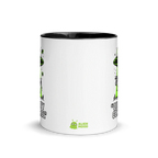 White mug with black interior and rim, featuring green alien graphics and text on a white background.