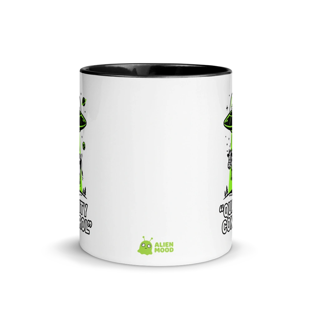 White mug with black interior and rim, featuring green alien graphics and text on a white background.